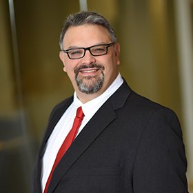 Dan_Forman seen in white color shirt and black color suit